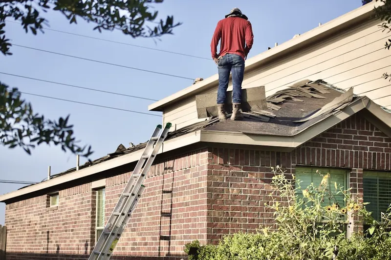 Professional roofer working on a residential roof in Mill Run Estates